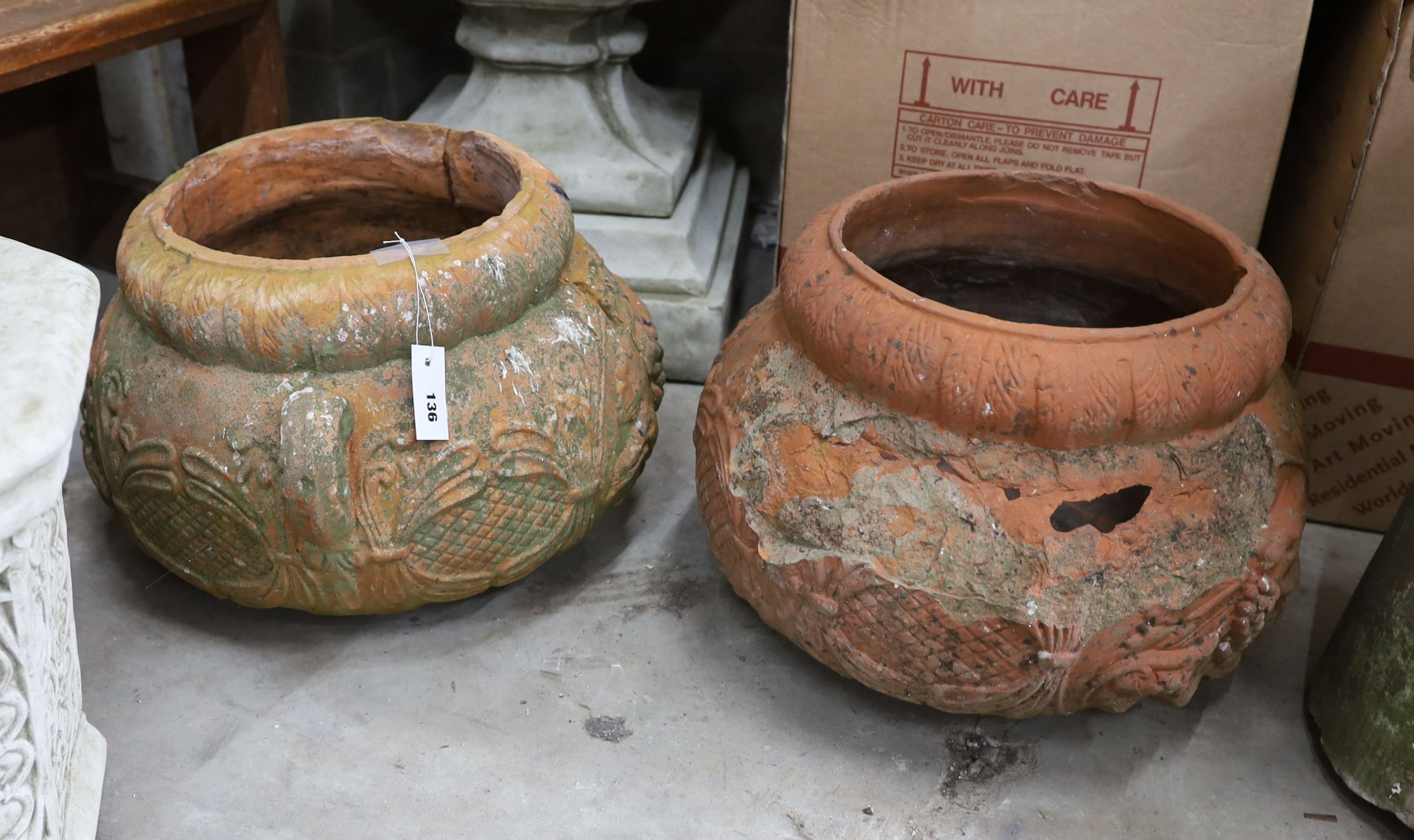 A pair of circular terracotta garden planters, diameter 50cm, height 34cm (damaged)